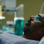 Person sleeping with a CPAP machine for sleep apnea treatment.